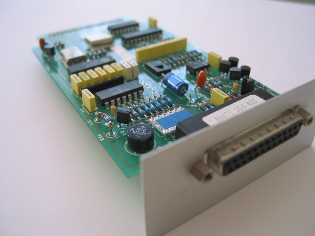 Analogue PCB close-up showing yellow capacitor filter bank and ICs
